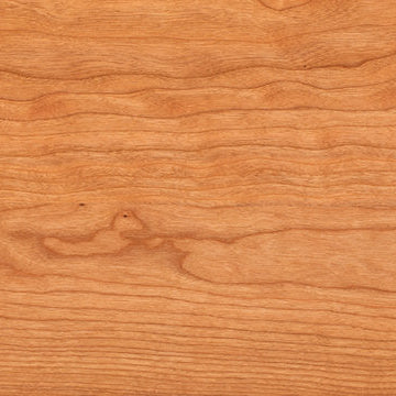 Close-up of a wooden surface with a warm brown color and visible grain pattern.