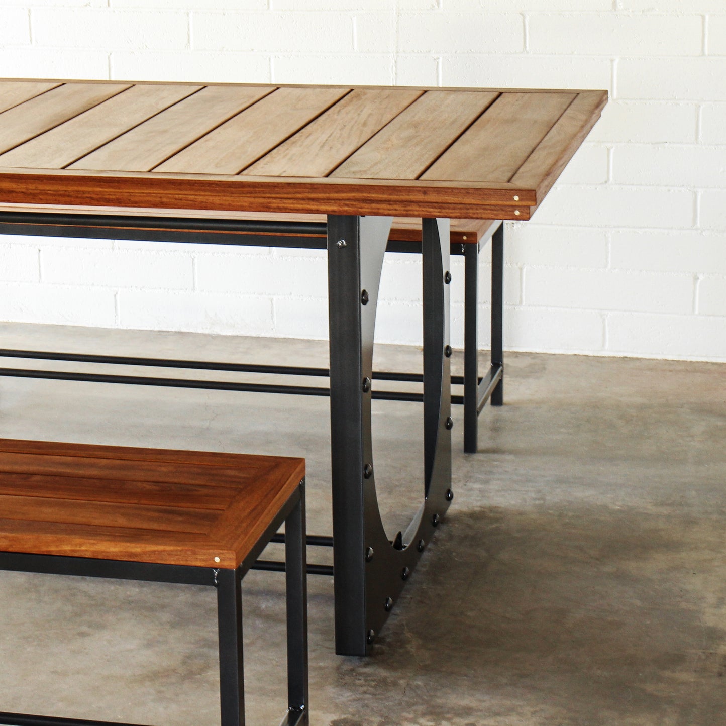 Outdoor dining table set-Table including two benches. Metal base, cumaru top, brass inlays.