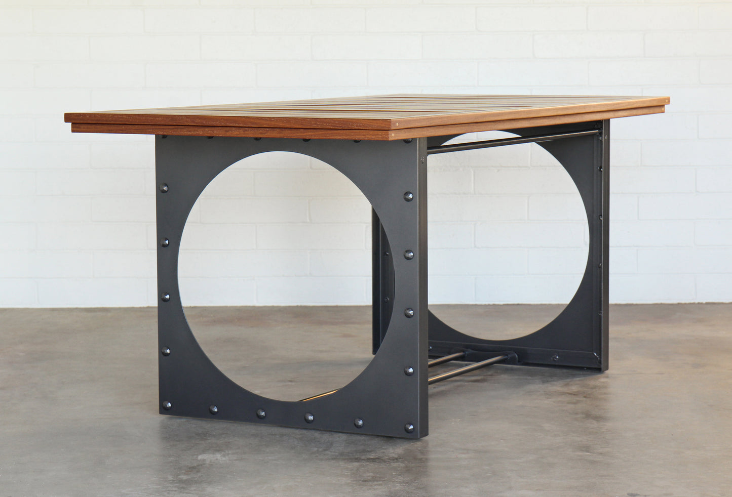 Outdoor dining table. Metal base, cumaru top, brass inlays.