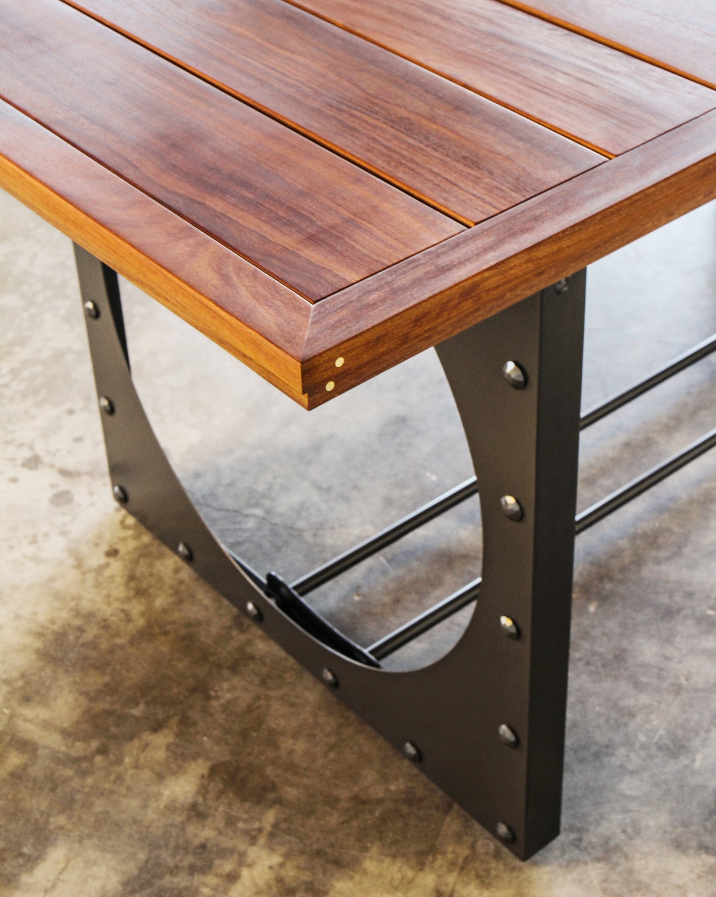 Outdoor dining table. Metal base, cumaru top, brass inlays.