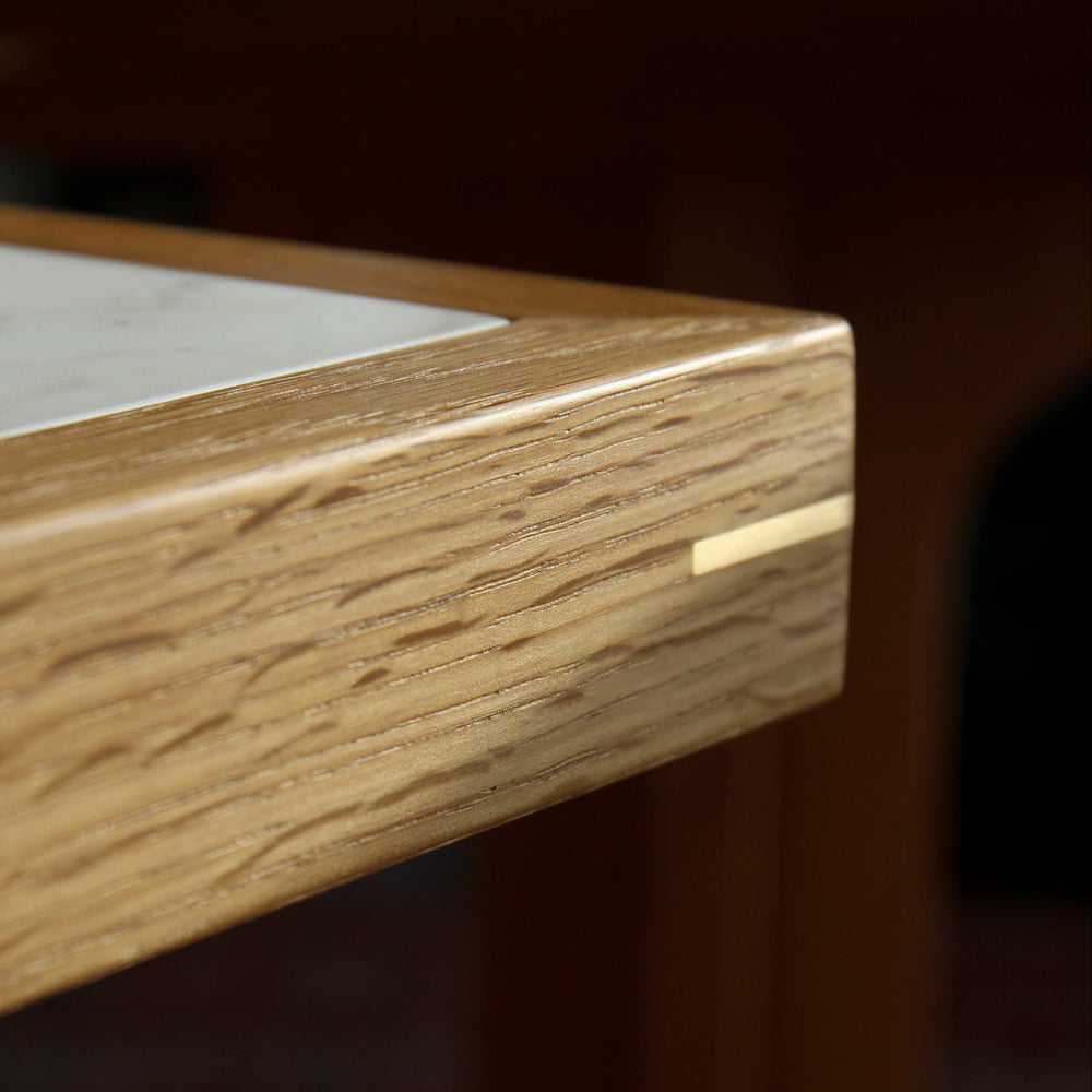 Close-up of a wooden furniture edge with marble inlay