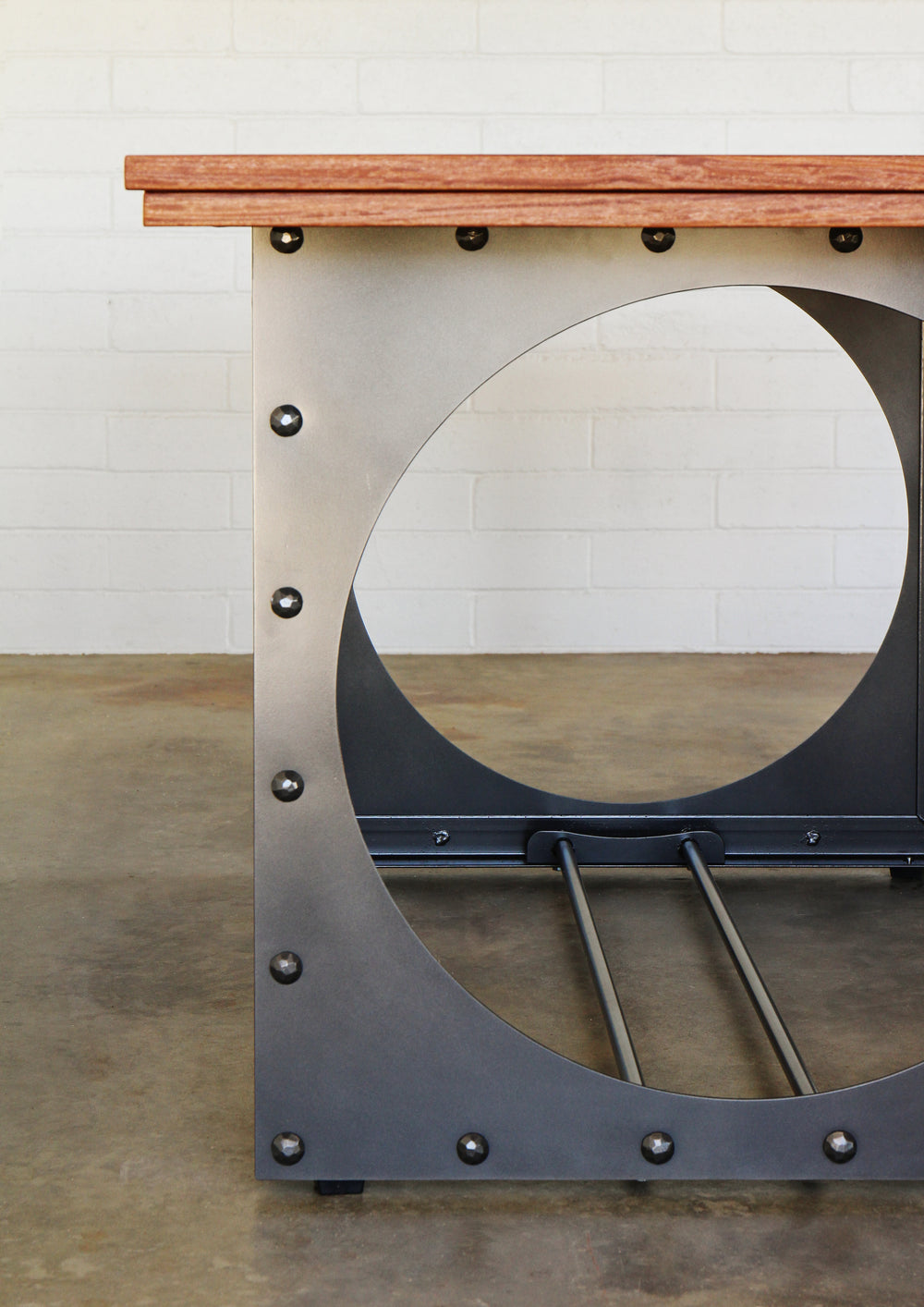 Outdoor dining table.  Metal base, cumaru top, brass inlays. 